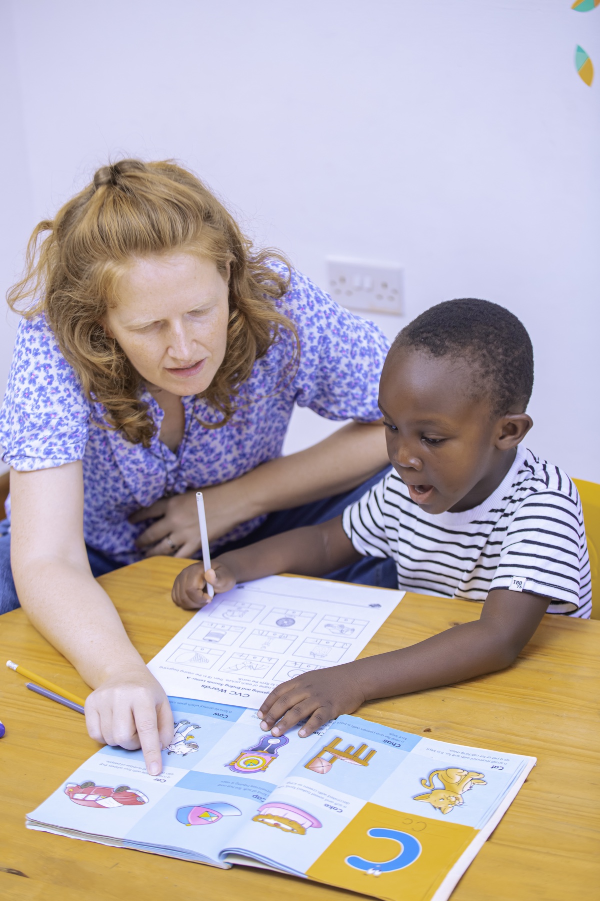 An Evermont teacher guiding a child through a learning activity