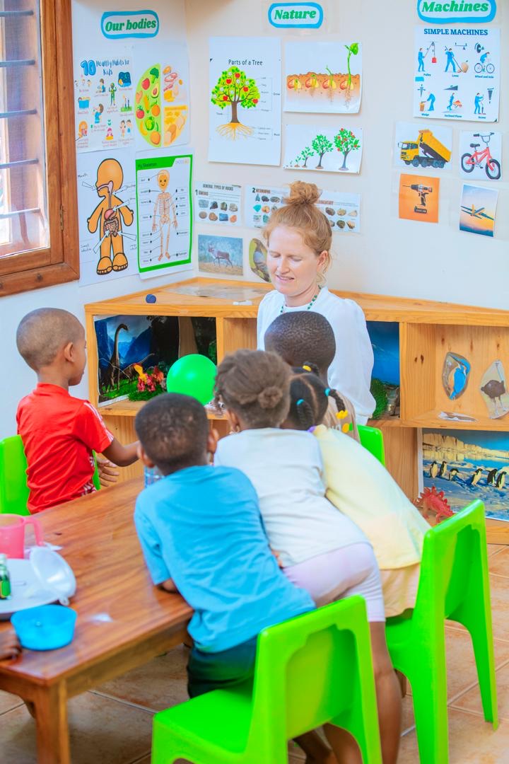 Evermont teacher guiding children during a classroom science activity