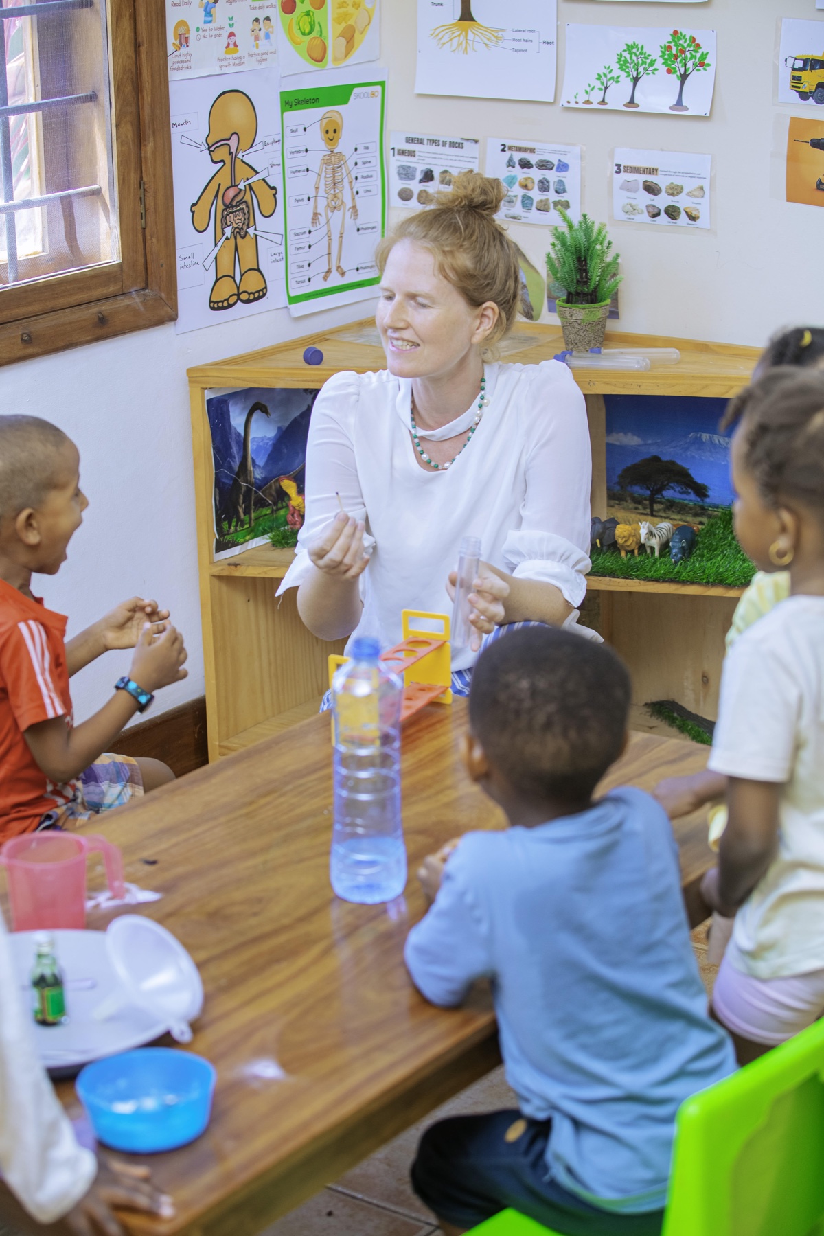 An Evermont teacher guiding children through a science activity