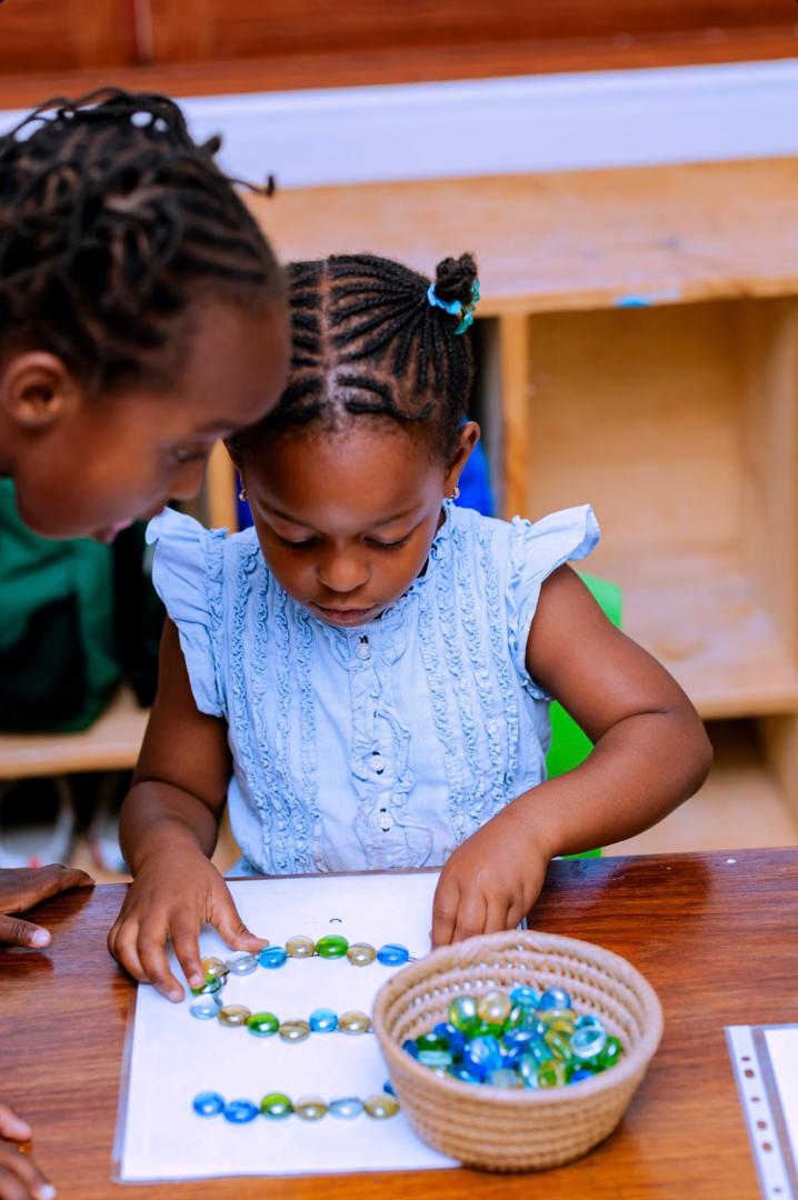 Evermont children practising letters through a hands-on sensory activity